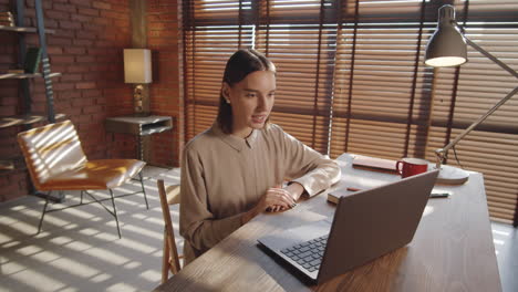 Pretty-Businesswoman-Web-Calling-on-Laptop-in-Office